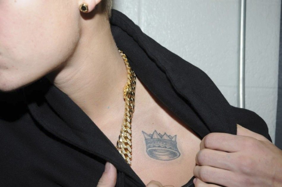 Canadian pop singer Justin Bieber shows a tattoo while in police custody in Miami Beach, Florida January 23, 2014 in this Miami Beach Police Department handout released to Reuters on March 4, 2014. Bieber was charged with driving under the influence, resi