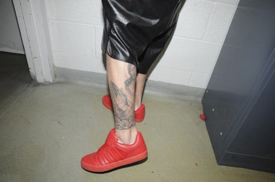 Canadian pop singer Justin Bieber shows a tattoo while in police custody in Miami Beach, Florida January 23, 2014 in this Miami Beach Police Department handout released to Reuters on March 4, 2014. Bieber was charged with driving under the influence, resi