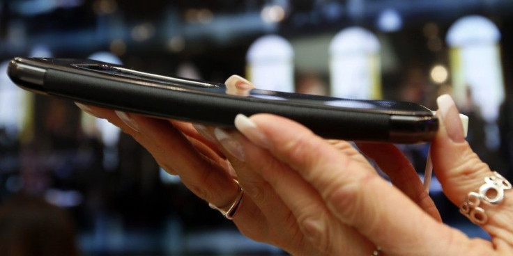 A Model Holds a Curved LG G Flex Smartphone During the Mobile World Congress in Barcelona