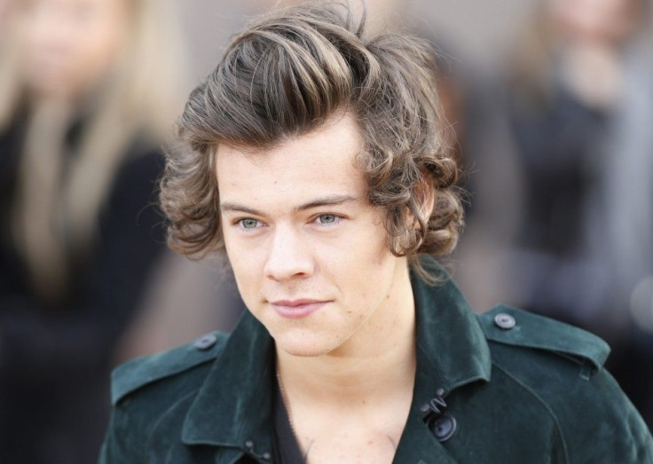 British singer Harry Styles from the band One Direction arrives to attend the presentation of the Burberry Autumn/Winter 2014 collection during the London Fashion Week.