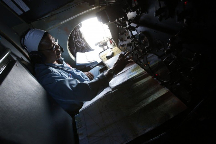 A military officer takes notes during a search and rescue mission, onboard an aircraft belonging to the Vietnamese airforce