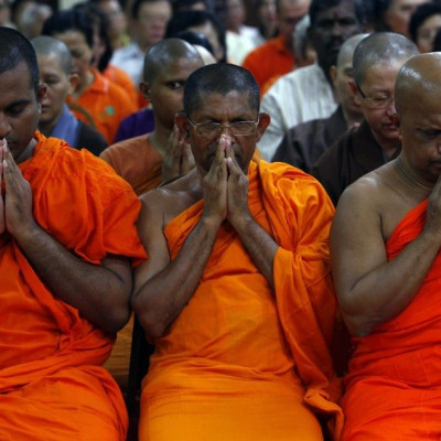 Buddhist monks pray during an interfaith prayer for the passengers and crew of the missing Malaysia Airlines flight MH370, at a Buddhist temple in Kuala Lumpur