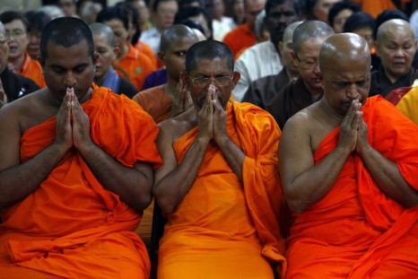 Buddhist monks pray during an interfaith prayer for the passengers and crew of the missing Malaysia Airlines flight MH370, at a Buddhist temple in Kuala Lumpur