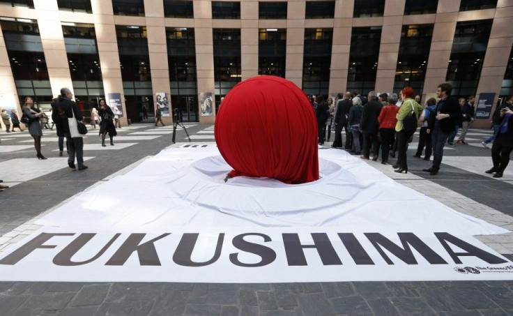 A banner that reads &quot;Fukushima&quot; is placed in front of a giant symbolic Japan's national flag to mark the third year anniversary of the March 11, 2011 earthquake and tsunami, at the European Parliament in Strasbourg, March 11, 2014. REUTERS/