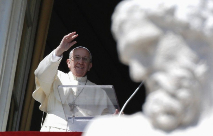 Pope Francis waves as he leads the Angelus prayer from the window of the Apostolic palace in Saint Peter's Square at the Vatican March 9, 2014. REUTERS/Max Rossi