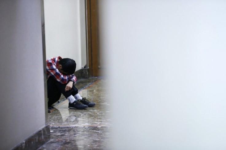 A friend of a passenger onboard the missing flight MH370 cries at the lobby of a hotel in Beijing