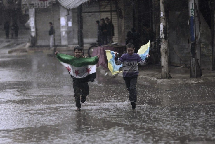 Children run in the heavy rain while carrying a Syrian opposition flag (L) and a flag in Ukraine&#039;s national colours after a protest against Syria&#039;s President Bashar al-Assad and against Russia&#039;s intervention in Ukraine&#039;s political cris