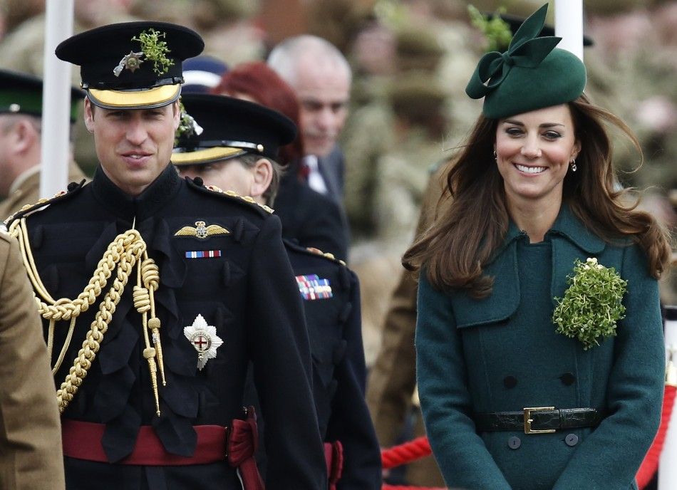 Britains Catherine, Duchess of Cambridge and her husband Prince William wear sprigs of shamrock during a visit to the 1st Battalion Irish Guards for a St Patricks Day Parade at Mons Barracks in Aldershot