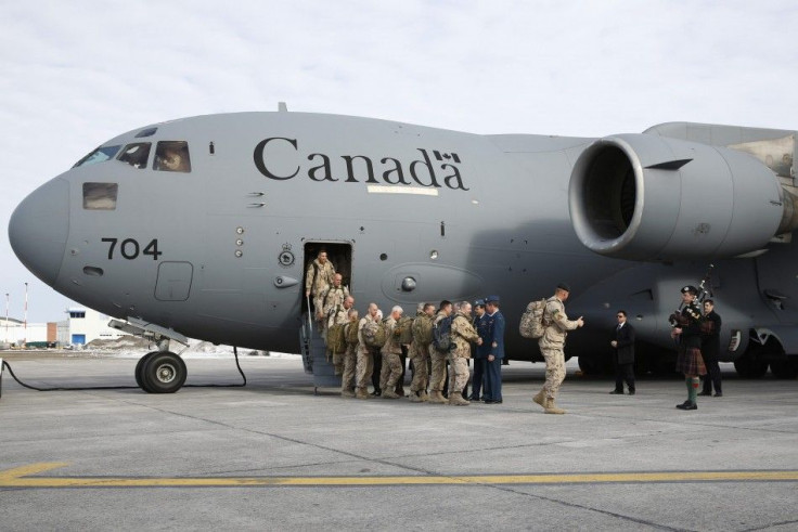 The last Canadian soldiers returning from Afghanistan are greeted by dignitaries as they deplane in Ottawa March 18, 2014. Canada&#039;s 12-year mission in Afghanistan has formally ended, according to the military. REUTERS/Blair Gable