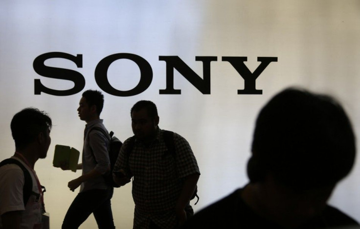 Indonesian Youth Walk Near a Sony Sign During Digital Imaging Expo in Jakarta