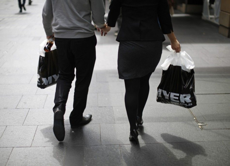 A couple hold hands as they walk through downtown Sydney with their shopping from Australian department store retailer Myer, March 6, 2014.  