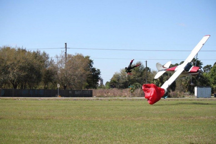 A small private plane piloted by Sharon Trembley crashes to the ground after getting tangled in the parachute of  skydiver John Frost before crashing to the ground at South Lakeland Airport March 8, 2014 in this handout photo provided by Tim Telford, cour