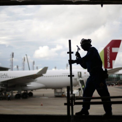 A worker is pictured during renovation and expansion works at Juscelino Kubitschek International Airport in Brasilia March 24, 2014. Brasilia is one of the host cities for the 2014 World Cup in Brazil. REUTERS/Ueslei Marcelino
