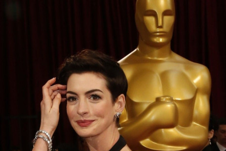 Actress Anne Hathaway, wearing a Gucci column dress, arrives at the 86th Academy Awards in Hollywood
