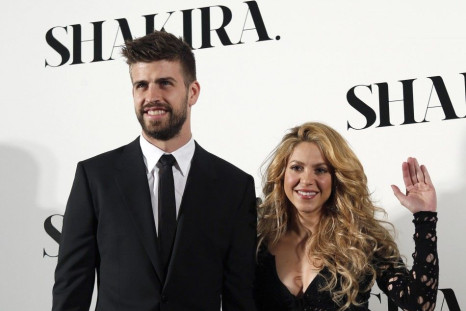 Colombian singer Shakira and Barcelona's soccer player Gerard Pique (L) pose during a photocall presenting her new album "Shakira" in Barcelona March 20, 2014. REUTERS/Albert Gea