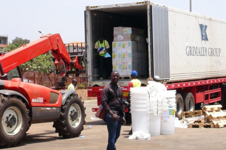 Workers from Doctors Without Borders unload emergency medical supplies to deal with Ebola 