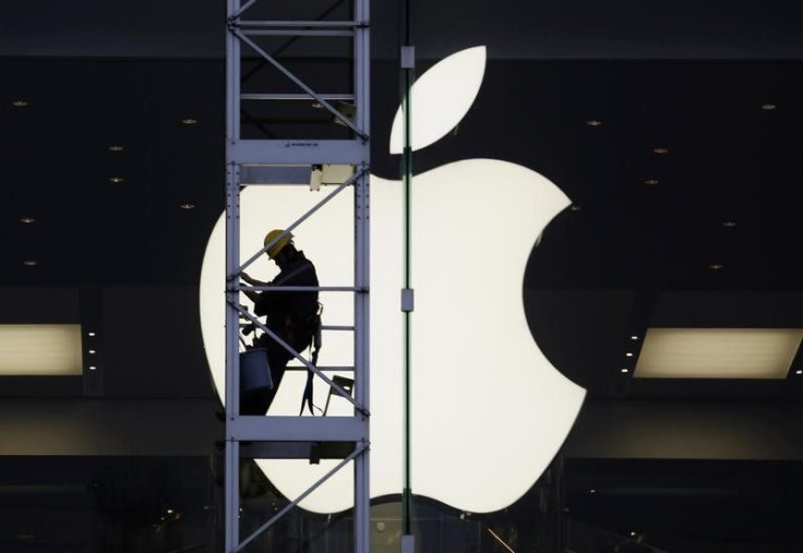 A worker climbs outside an Apple store in Hong Kong