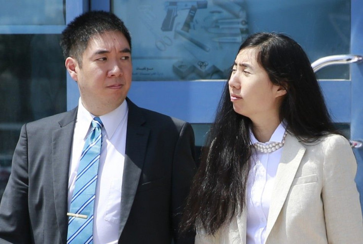 Matthew and Grace Huang, a U.S. couple who were accused of murdering their adopted daughter Gloria, stand outside the entrance of the Court of First Instance after their trial in Doha