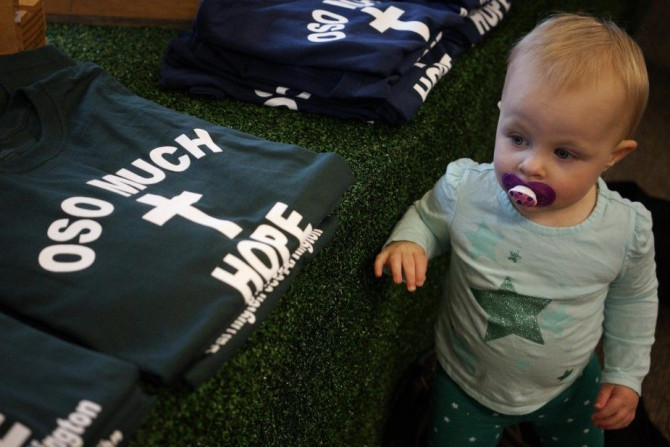 A child looks at the new Oso mudslide support t-shirts in the Action Sports shop in downtown Arlington, Washington