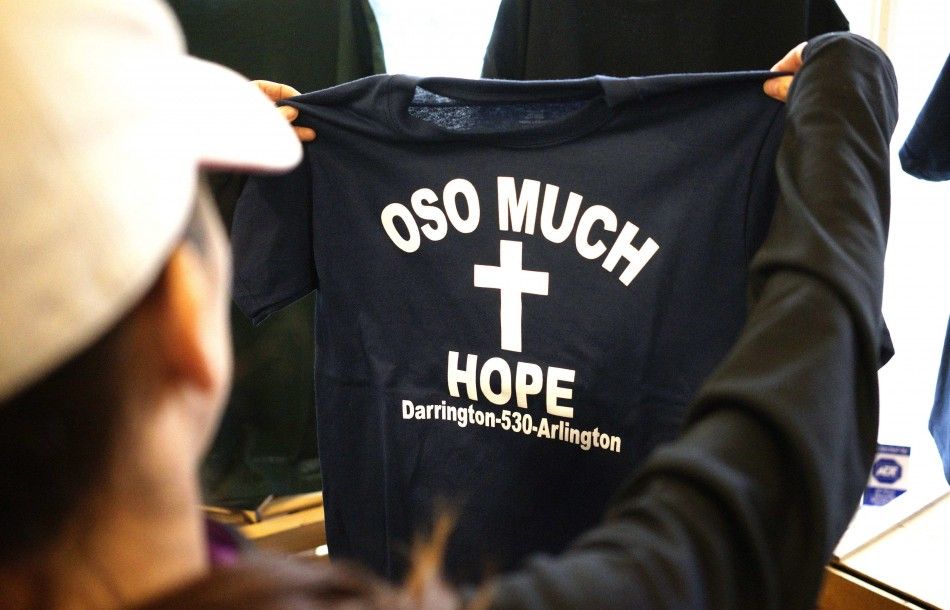 A woman looks at a new Oso mudslide support t-shirt in the Action Sports shop in downtown Arlington, Washington
