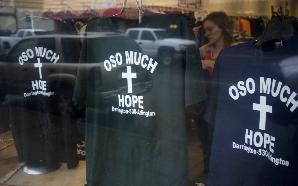 A woman looks at the new Oso mudslide support t-shirts in the Action Sports shop in downtown Arlington, Washington