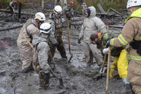 Personnel from the Washington National Guard join civilian workers in efforts to find missing persons following a deadly mudslide in Oso, Washington