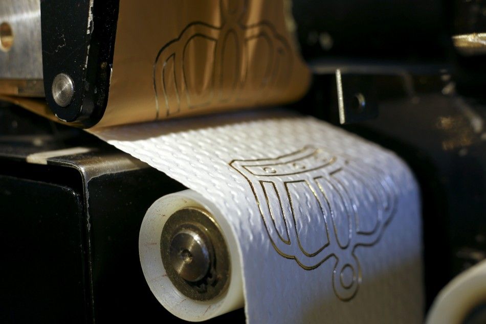 Combination photo shows various 24 carat gold motifs on luxury toilet paper at the Tissue Design workshop of Fritz Loibl in Grafenau