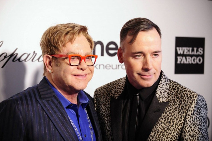 John and Furnish pose at the 2014 Elton John AIDS Foundation Oscar Party in West Hollywood