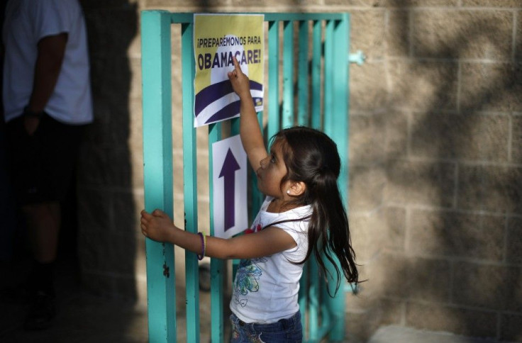 Tello points to a sign outside a health insurance enrollment event in Cudahy, California