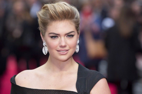 Actress and model Kate Upton poses for photographers as she arrives for the UK Gala screening of The Other Woman in London