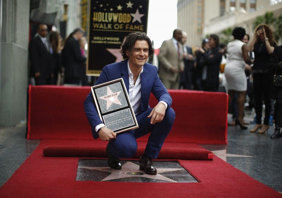 Actor Orlando Bloom of Britain watches as his son Flynn unveils his star on the Hollywood Walk of Fame in Hollywood, Los Angeles
