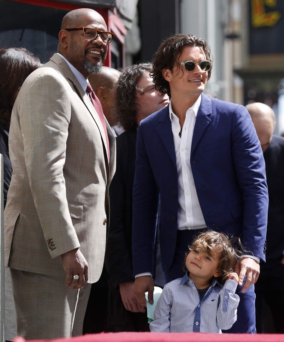 Actor Orlando Bloom of Britain stands with his son Flynn and actor Forest Whitaker before receiving a star on the Hollywood Walk of Fame in Hollywood, Los Angeles