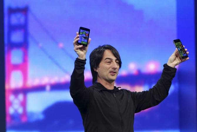 Joe Belfiore holds a pair of mobile phones featuring the new Windows 8.1 operating system during the company's &quot;build&quot; conference in San Francisco