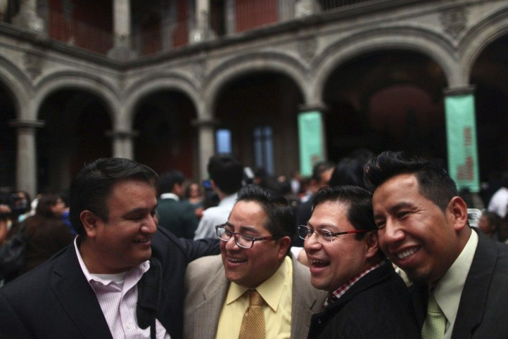 Gay couples smile during a mass wedding in Mexico City