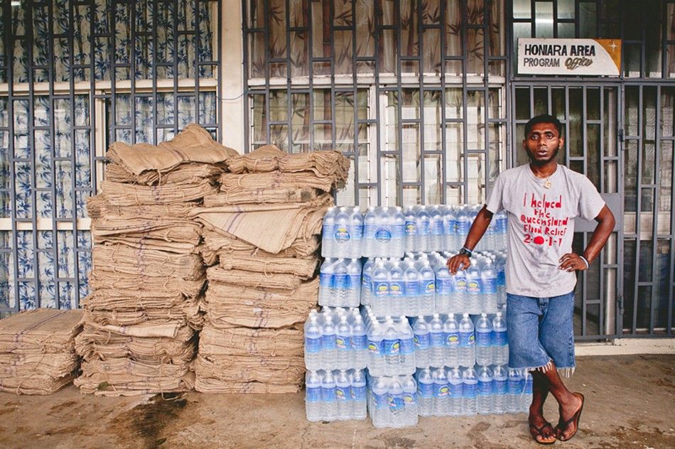 A relief worker stands next to supplies of blankets and water at a distribution center after severe flooding in the capital Honiara in the Solomon Islands in this picture released by World Vision April 6, 2014. Local media reported that the United Nations