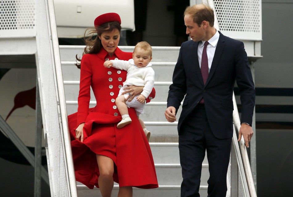 Britains Prince William, his wife Catherine, Duchess of Cambridge, and their son Prince George disembark from their plane after arriving in Wellington