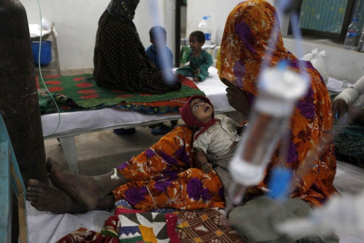 A woman displaced from a drought-stricken area takes care of her baby boy, who is suffering stomach infection, at the Civil Hospital in Mithi, in the Sindh province March 12, 2014. Dozens of children have died of malnutrition and other causes in Pakistan&