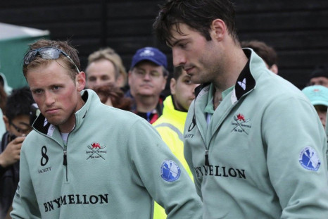 Cambridge&#039;s number 2 Luke Juckett and number 4 Steve Dudek react after being beaten by Oxford in the 160th Boat Race on the River Thames in London