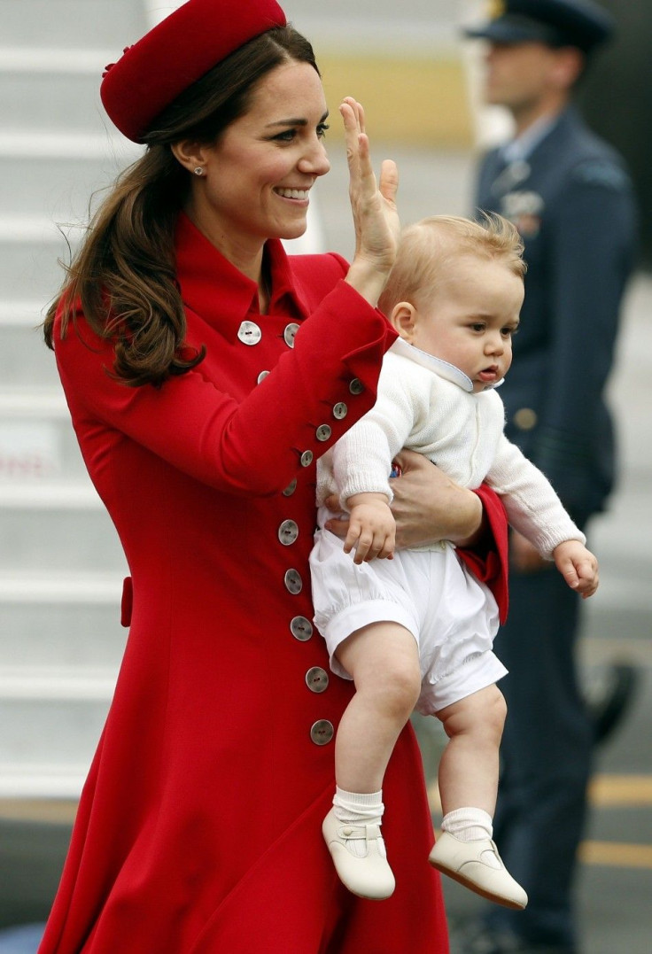 Catherine, the Duchess of Cambridge, holds her son Prince George after disembarking their plane with her husband Britain's Prince William after arriving in Wellington