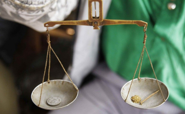 A trader weighs gold nuggets at an illegal mine-pit in Walungu territory of South-Kivu province near Bukavu, April 5, 2014. Democratic Republic of Congo aims to double tax revenues from minerals but investors warned that an overhaul of the mining code cou