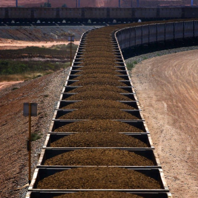 A train hauling carriages filled with iron ore is seen on the outskirts of Port Hedland in the Pilbara region of Western Australia in this December 3, 2013 file photo. If Australian miners are worried about the dramatic decline in iron ore prices, it does