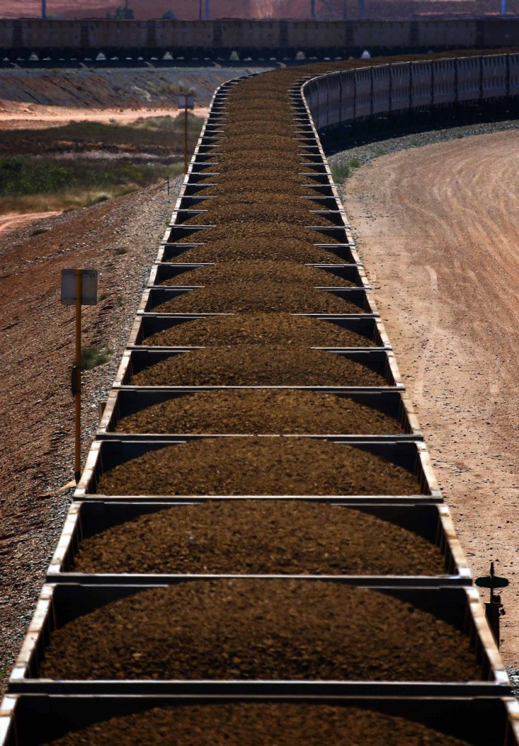 A train hauling carriages filled with iron ore is seen on the outskirts of Port Hedland in the Pilbara region of Western Australia in this December 3, 2013 file photo. If Australian miners are worried about the dramatic decline in iron ore prices, it does
