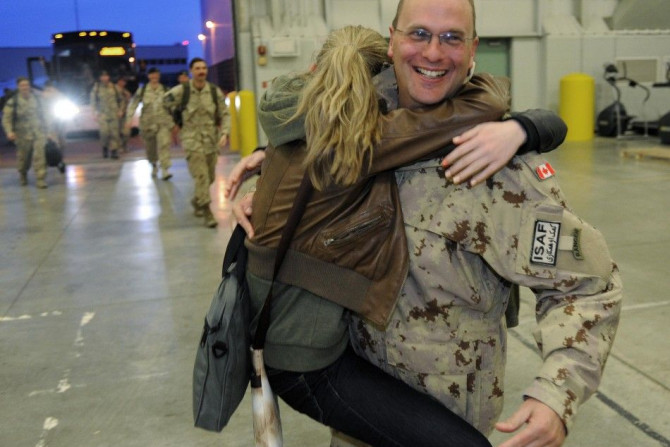 Lt.-Col Hammond receives a hug from his daughters as the last of Canada&#039;s troops return home from Afghanistan to Edmonton Garrison