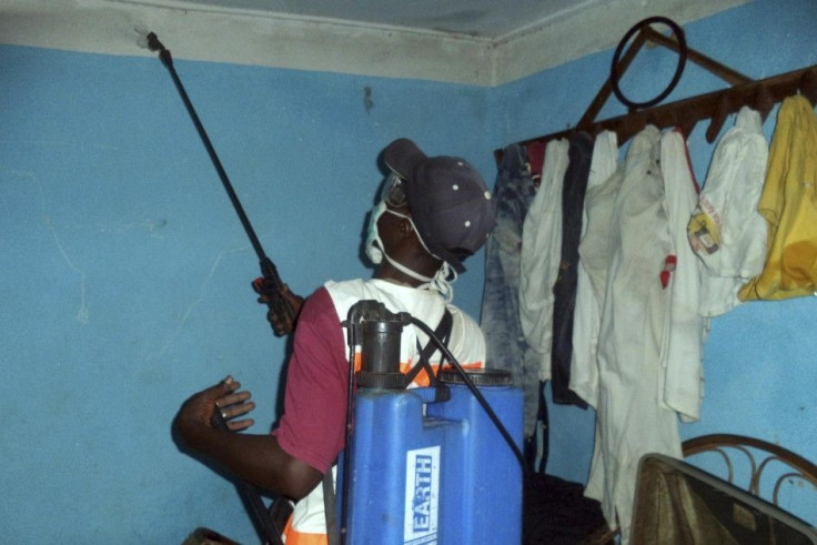 A health worker sprays disinfectant in a house belonging to someone suspected of coming into contact with Ebola virus in Macenta March 26, 2014 in this picture provided by Plan International. Authorities in Guinea scrambled on Friday to halt the spread of