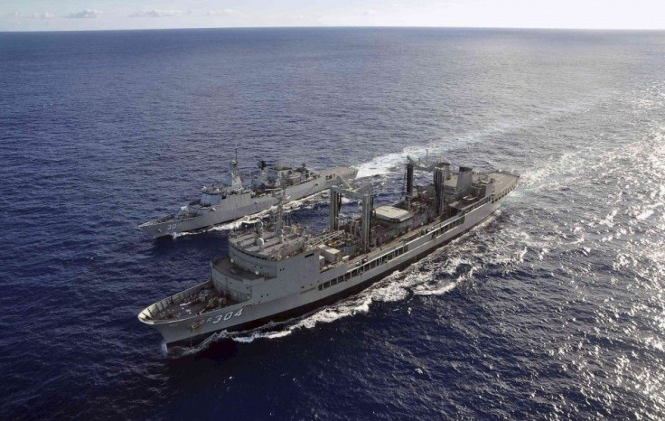 The Australian Navy ship HMAS Success (front) performs a Replenishment at Sea evolution with the Royal Malaysian Navy ship KD Lekiu