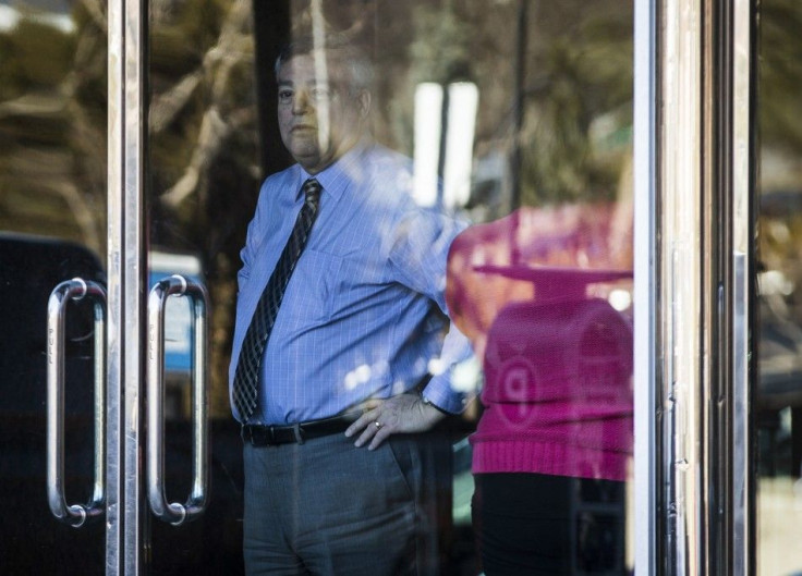 A Man Looks Outside from a Building in a Office Complex Where Multiple Stabbings have Occurred in Toronto