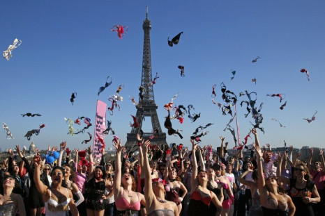 Women toss their bras during the 5th Pink Bra Spring and Bra Toss and help Push Up the Fight Against Breast Cancer at the Trocadero Square near the Eiffel Tower in Paris