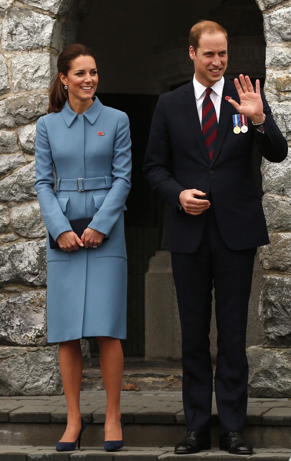 Britains Prince William and his wife Catherine, the Duchess of Cambridge, stand together after laying a wreath at the war memorial in the town of Blenheim