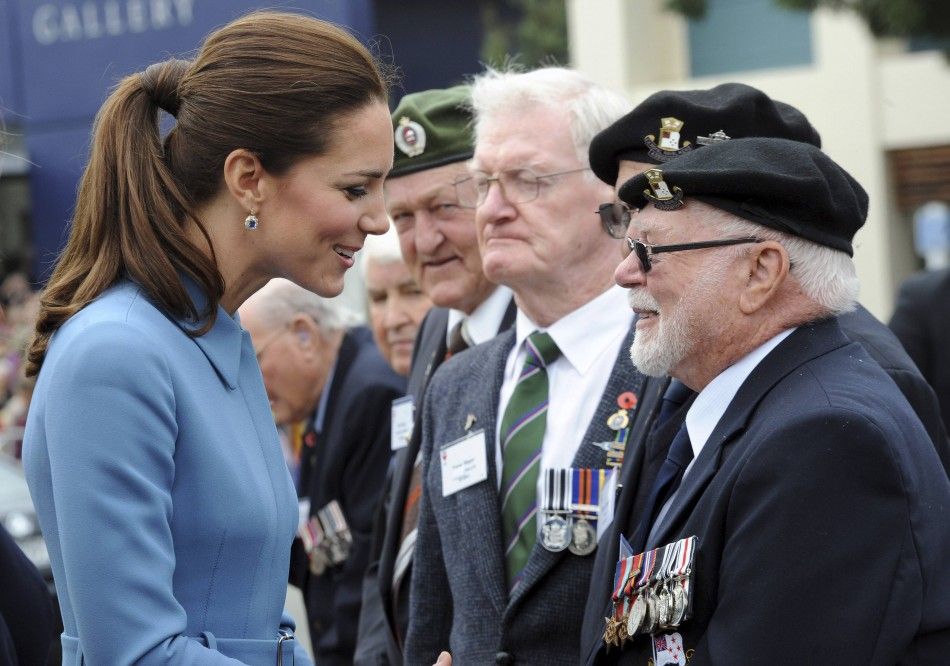 Catherine, the Duchess of Cambridge, reacts as she greets war veterans after laying a wreath with her husband, Britains Prince William, at the war memorial in Seymour Square