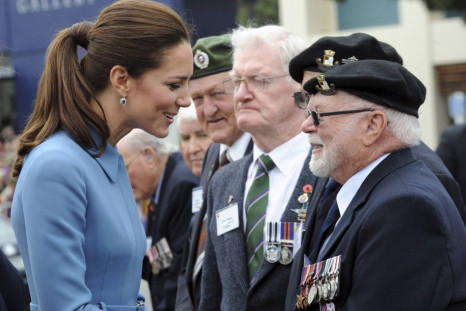 Catherine, the Duchess of Cambridge, reacts as she greets war veterans after laying a wreath with her husband, Britain's Prince William, at the war memorial in Seymour Square
